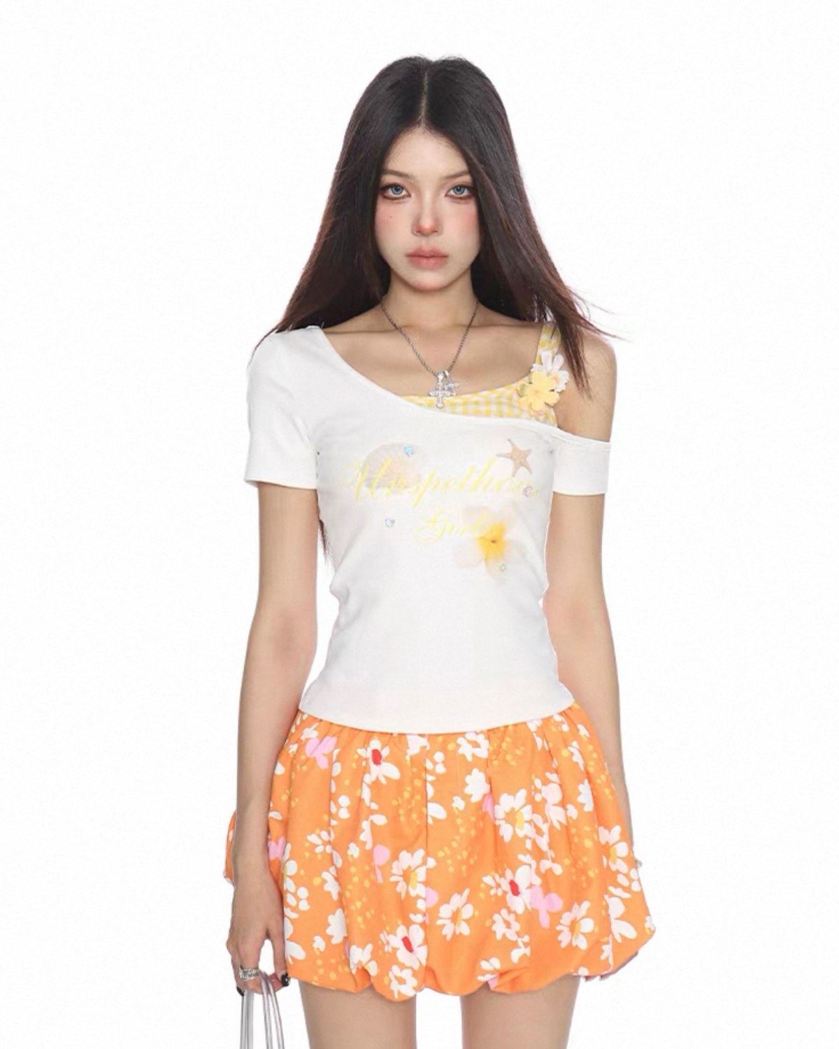 Woman wearing a white top with floral design and an orange skirt with pink flowers on a white background