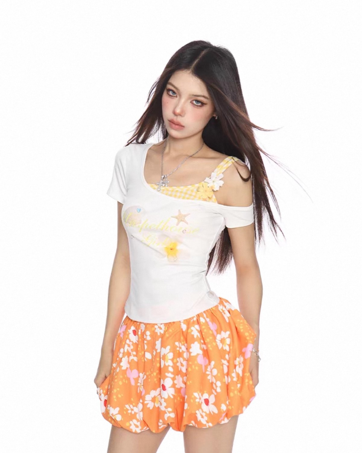 Woman wearing a white top with floral patterns and an orange skirt on a white background