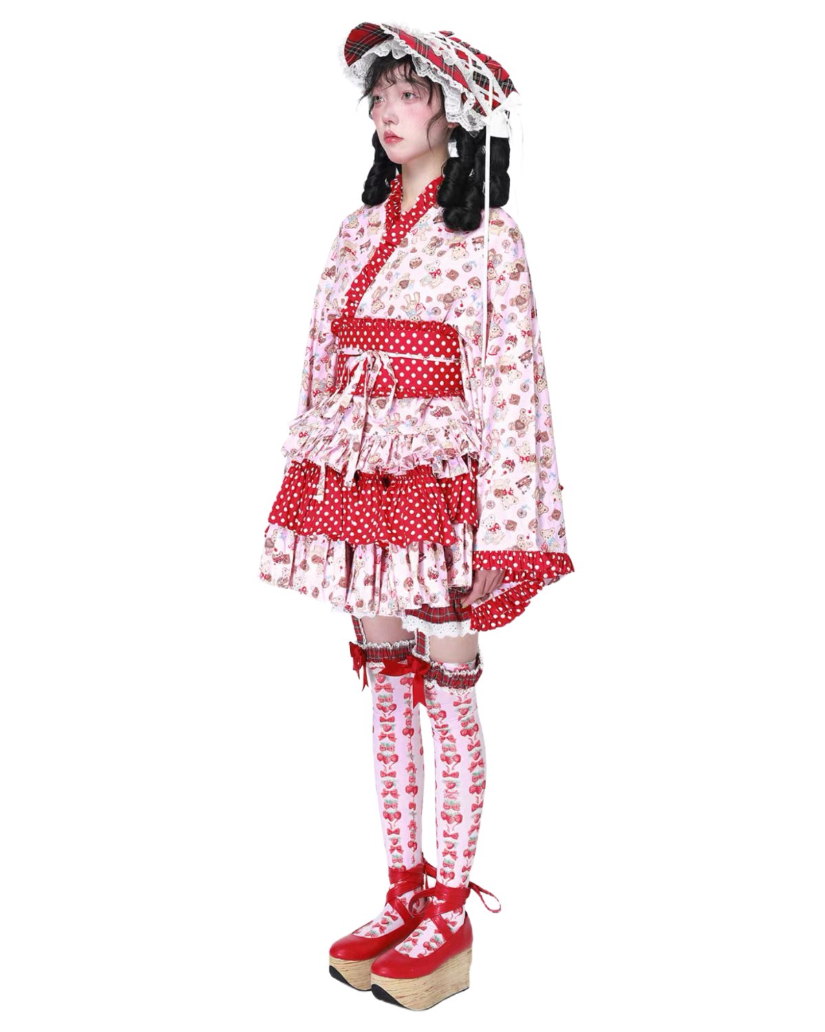 Person wearing a red and white polka dot outfit with matching shoes on a white background