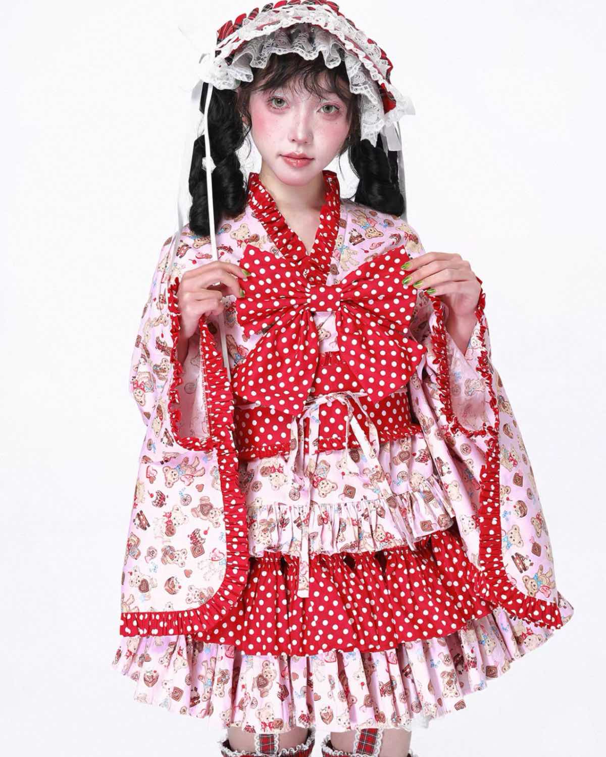 Person wearing a red and white polka dot dress with floral patterns on a white background