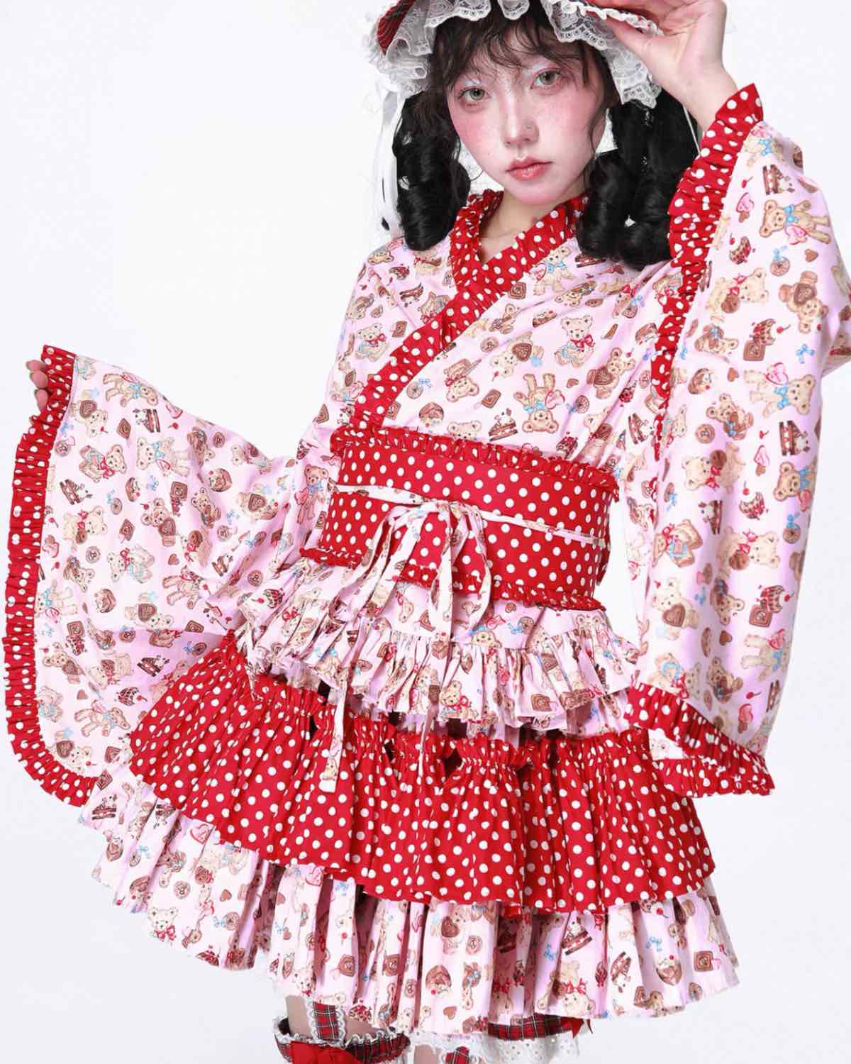 Person wearing a red and white polka dot dress with floral patterns on a white background