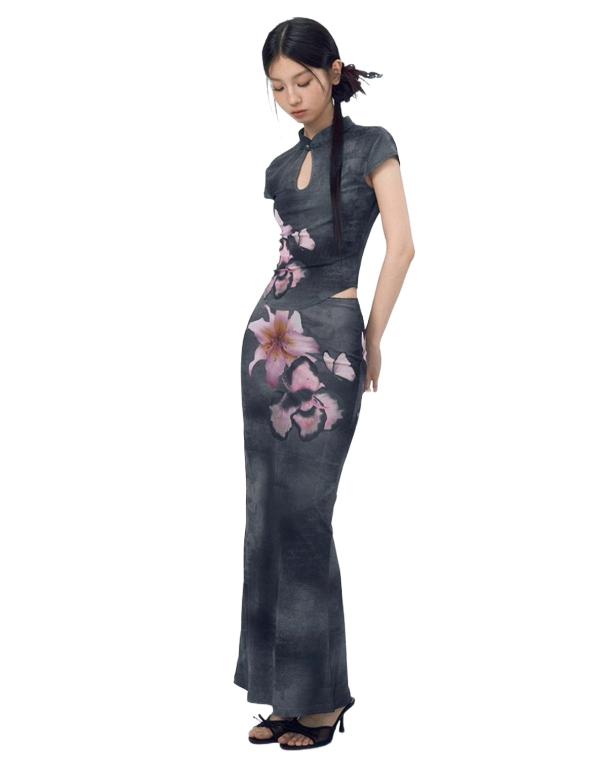 Woman wearing a gray dress with floral patterns on a white background