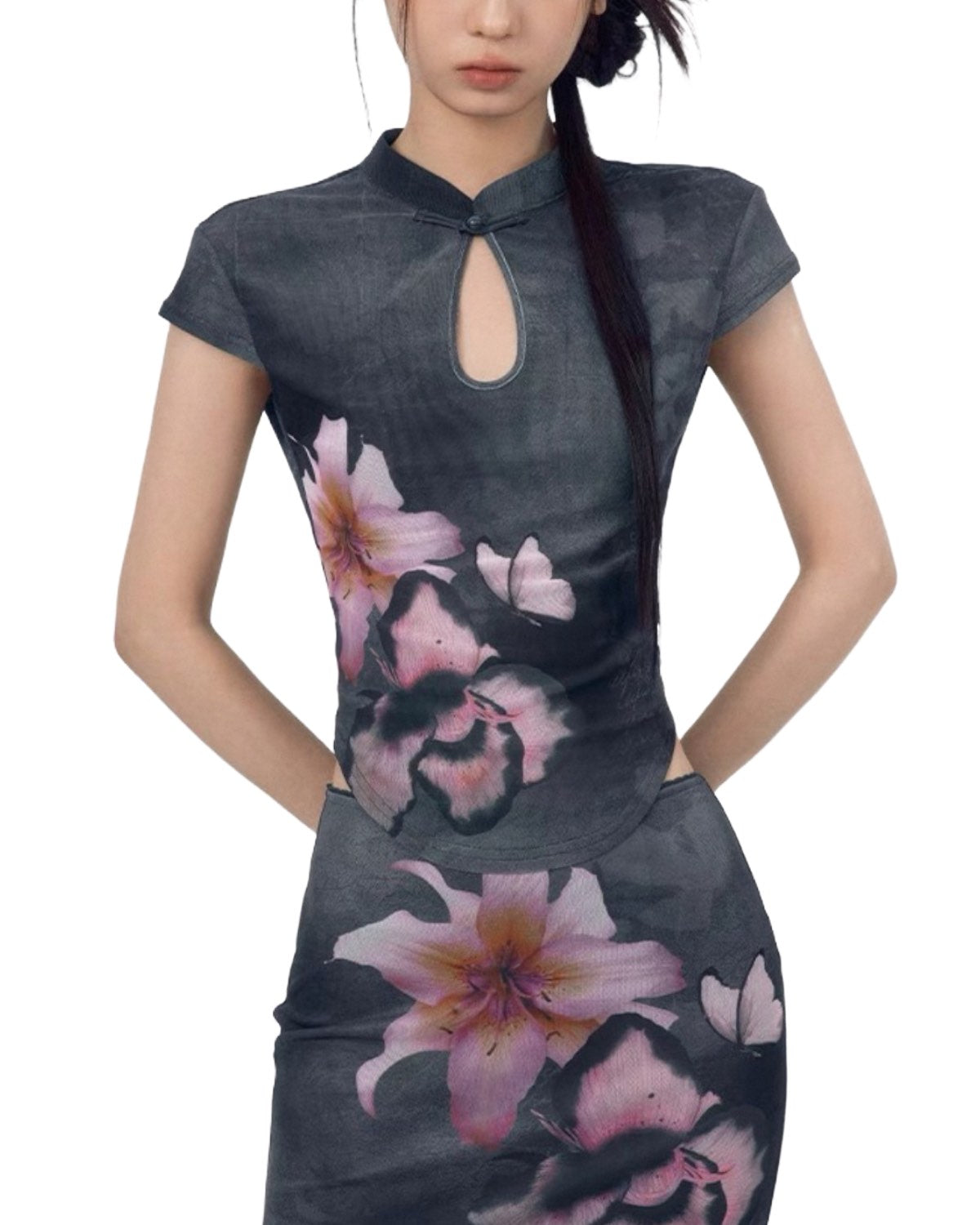 Woman wearing a dark gray dress with floral patterns on a white background