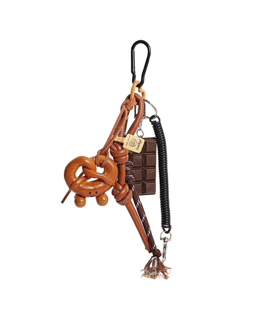 Brown leather keychain with decorative elements on a white background