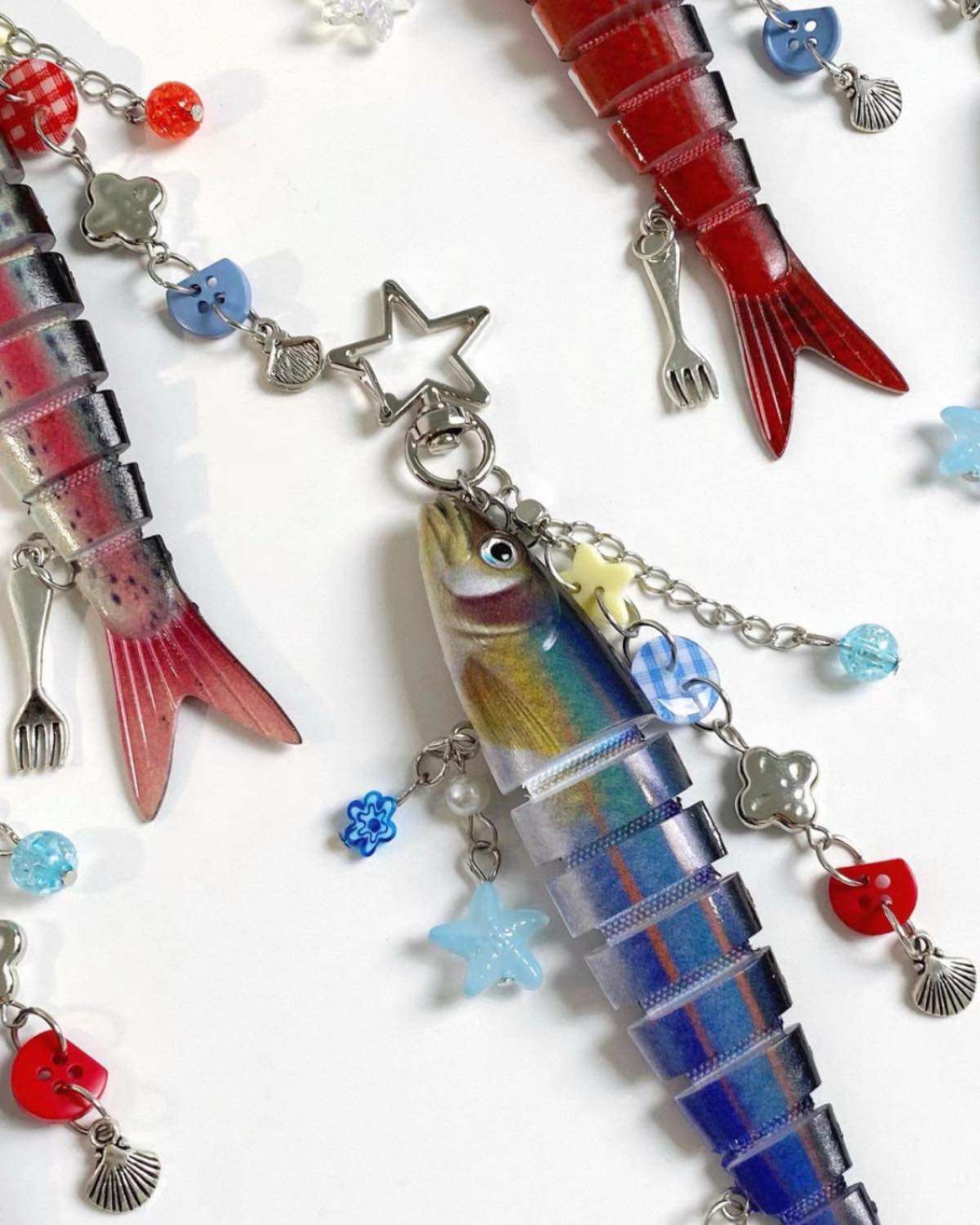 Colorful fish-shaped charms on a white background