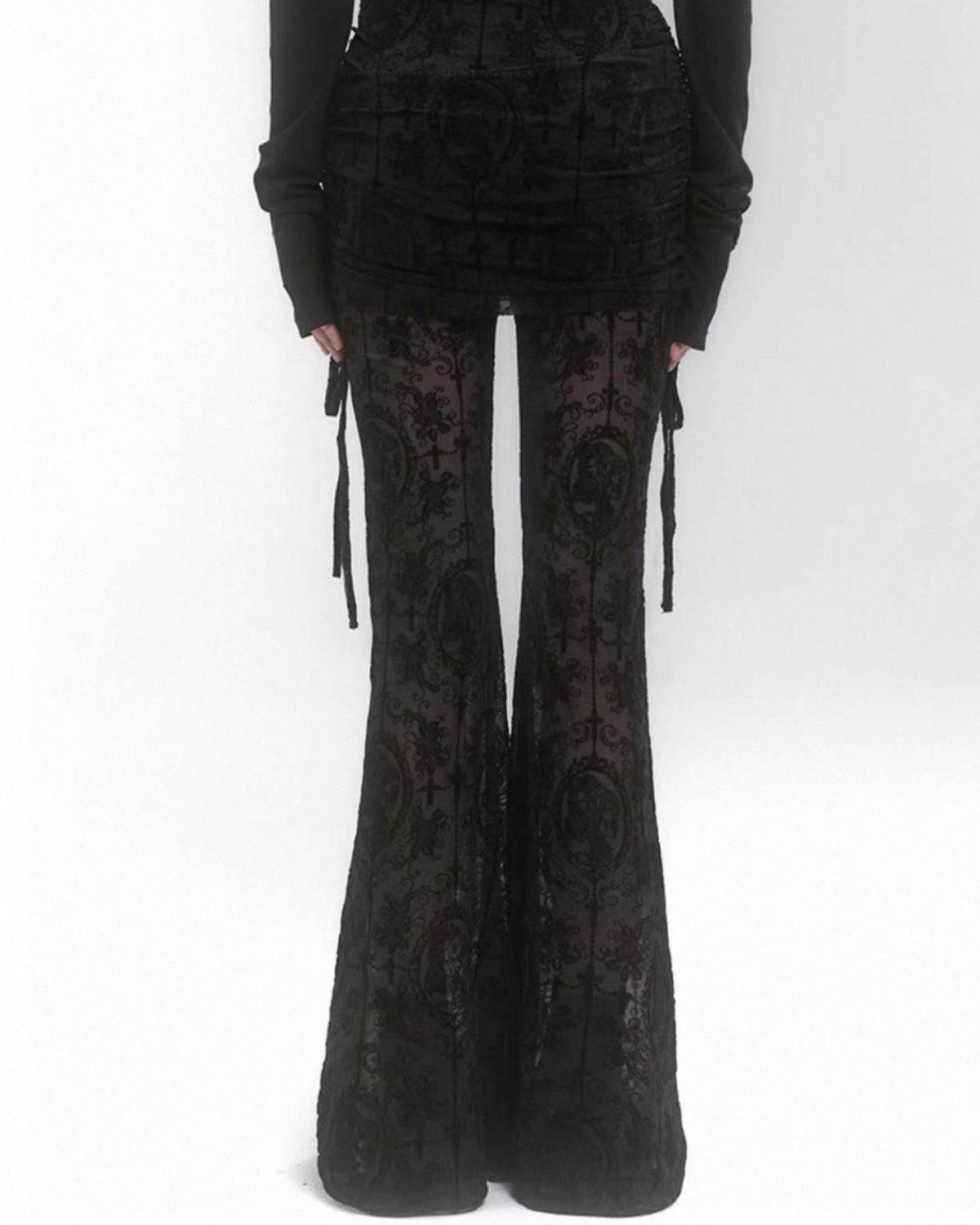 Black patterned flared pants on a white background
