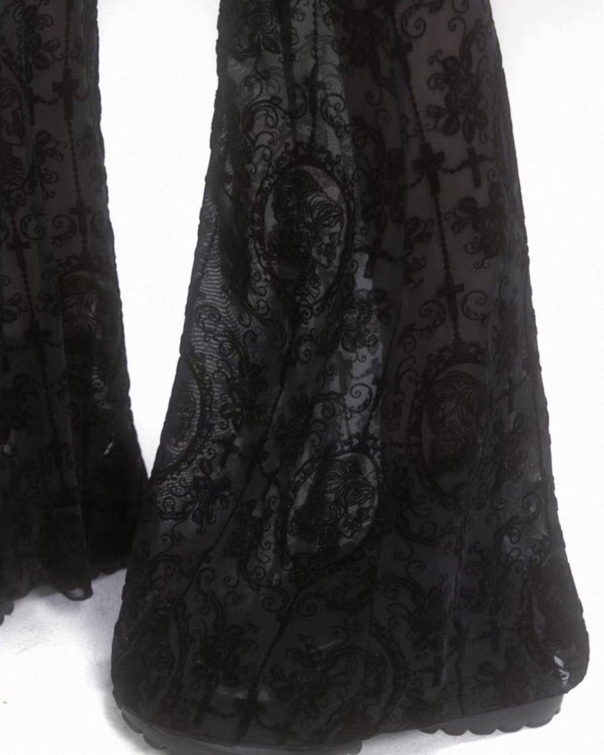 Black lace pants with goth patterns on a white background detail