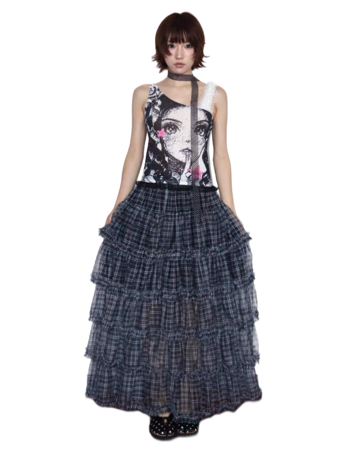 Woman wearing a sleeveless top with a graphic design and a tiered plaid skirt on a white background