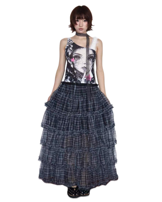 Woman wearing a sleeveless top with a graphic design and a tiered plaid skirt on a white background