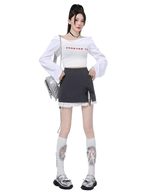 Person wearing a white long-sleeve top with text and a black skirt on a white background