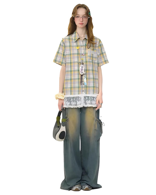 Person wearing a plaid shirt and wide-leg pants on a white background