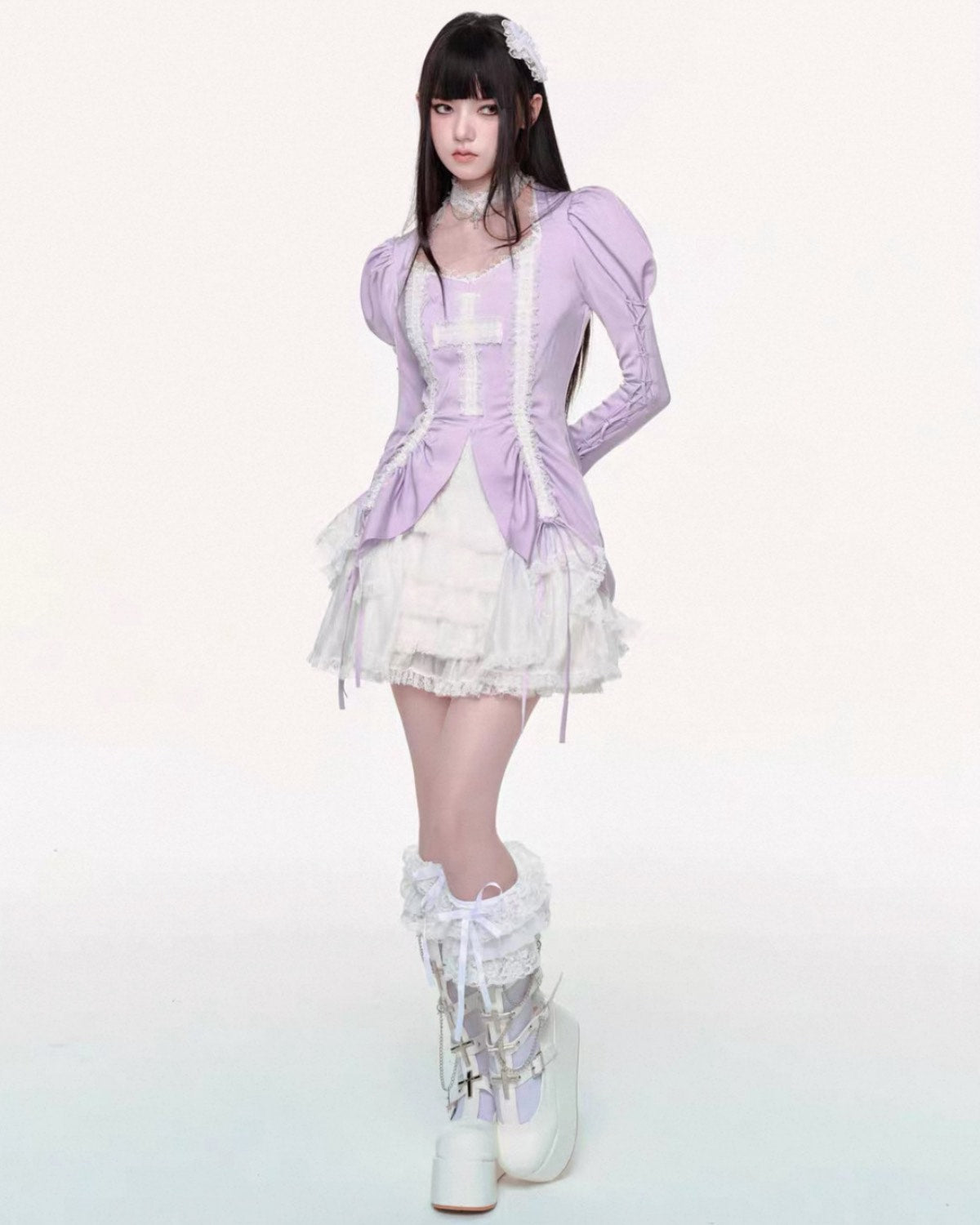 Person wearing a lavender outfit with white accents on a white background