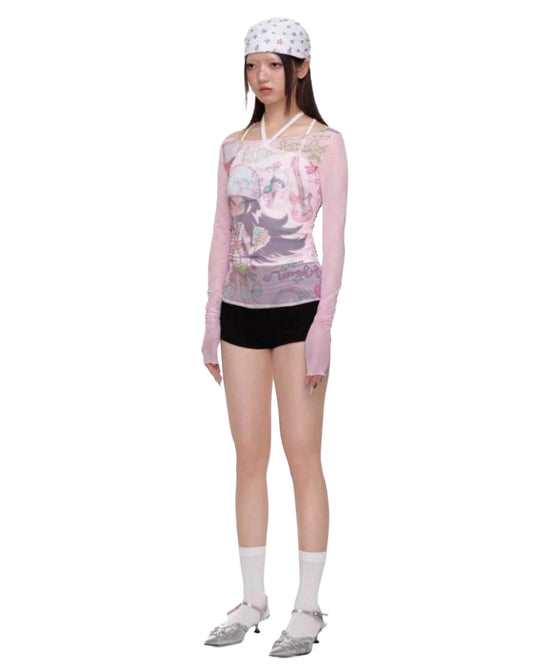 Person wearing a floral long-sleeve shirt and black shorts on a white background