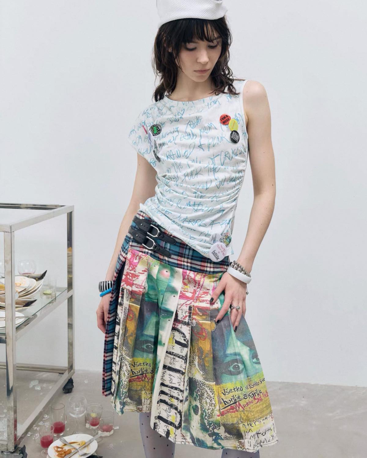 Woman wearing a colorful skirt and patterned top in an indoor setting