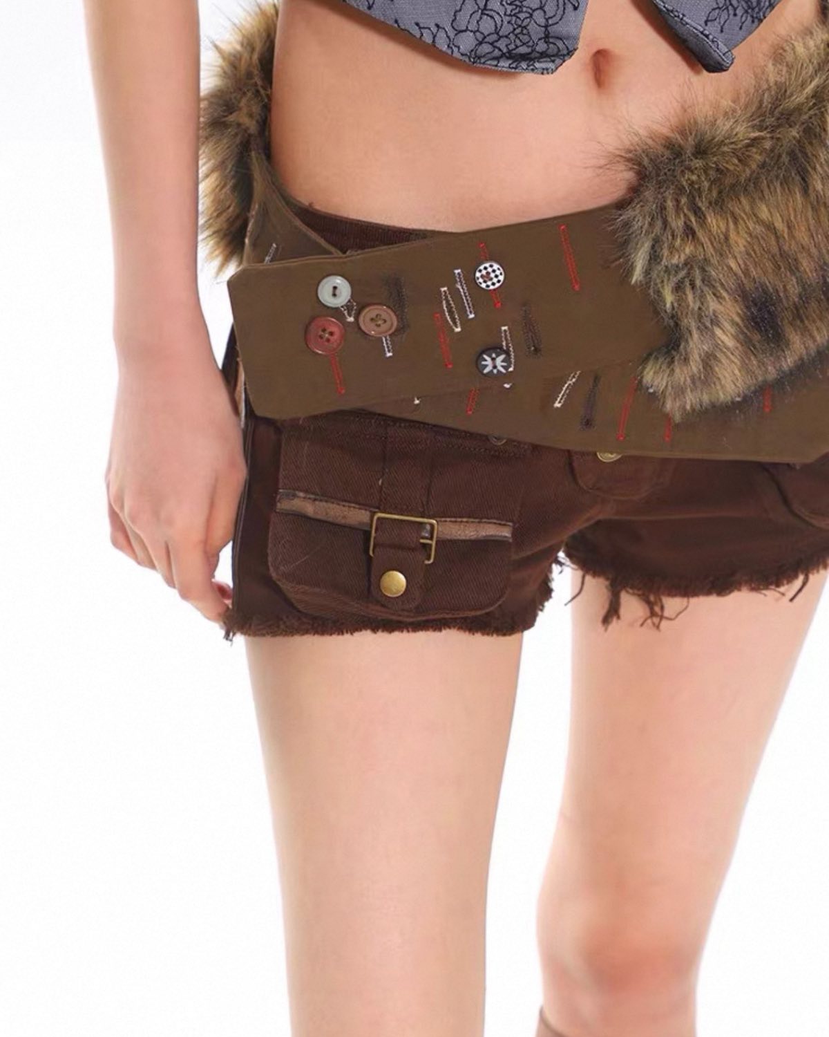 Brown shorts with fur trim and decorative buttons on a white background