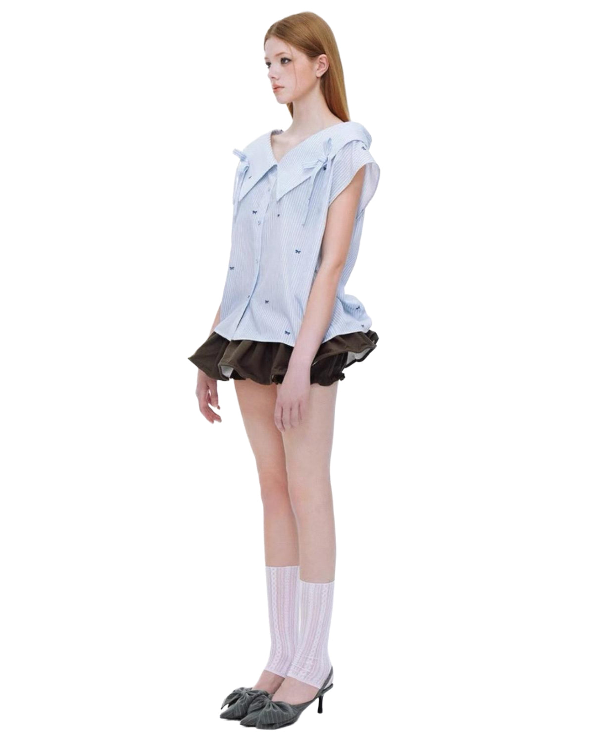 Model wearing a light blue sleeveless shirt with a brown skirt on a white background side view