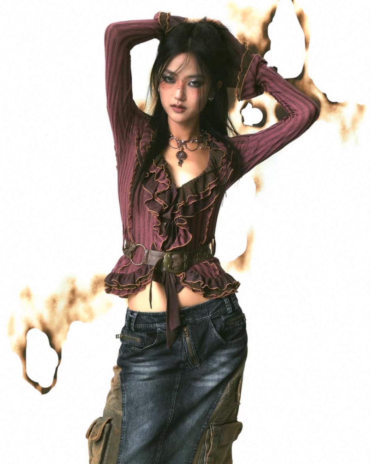 Woman wearing a purple top and blue jeans with a white background