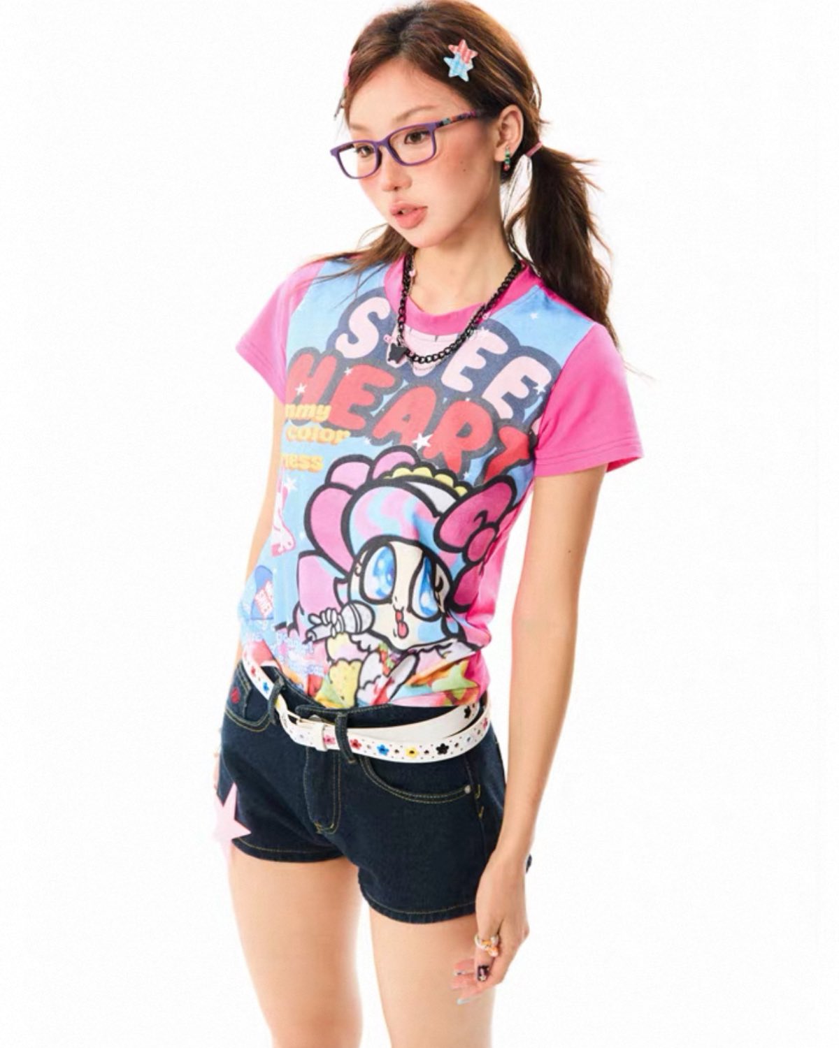 Person wearing a colorful graphic t-shirt with cartoon design on a white background