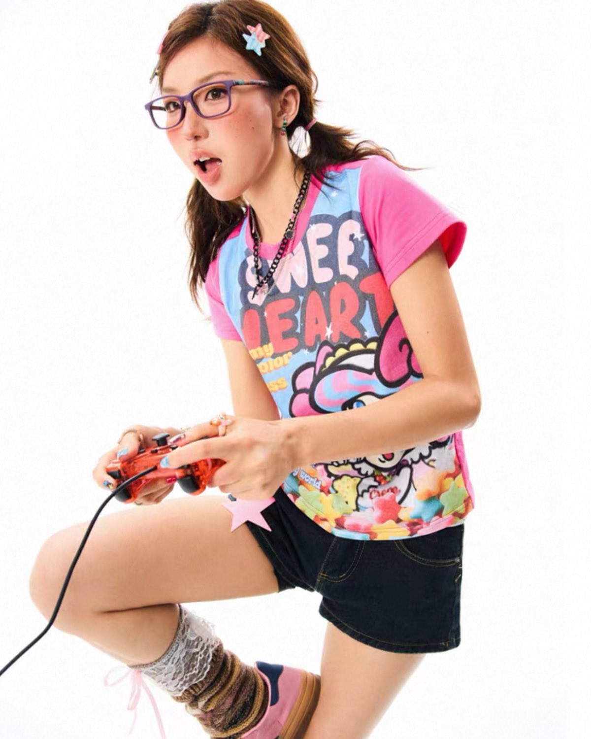 Woman playing a video game with colorful graphics on her shirt