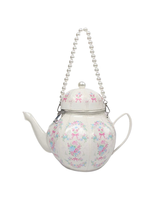 Teapot-shaped handbag with floral pattern and pearl chain on a white background