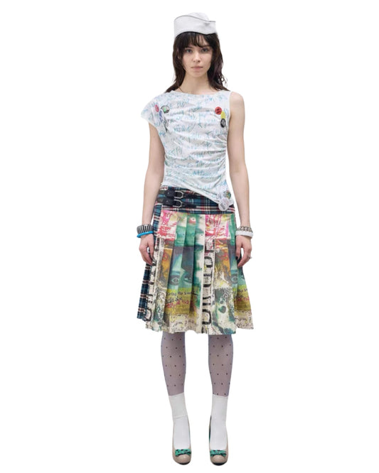 Woman wearing a patterned top and colorful skirt on a white background
