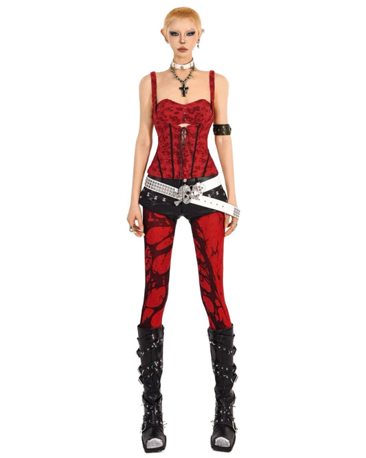Person wearing a red and black outfit with studded details on a white background