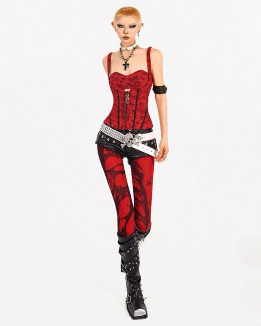 Model wearing a red and black outfit with a corset and pants on a white background